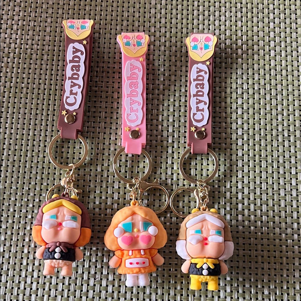 New CryBaby keychains or bag charms.